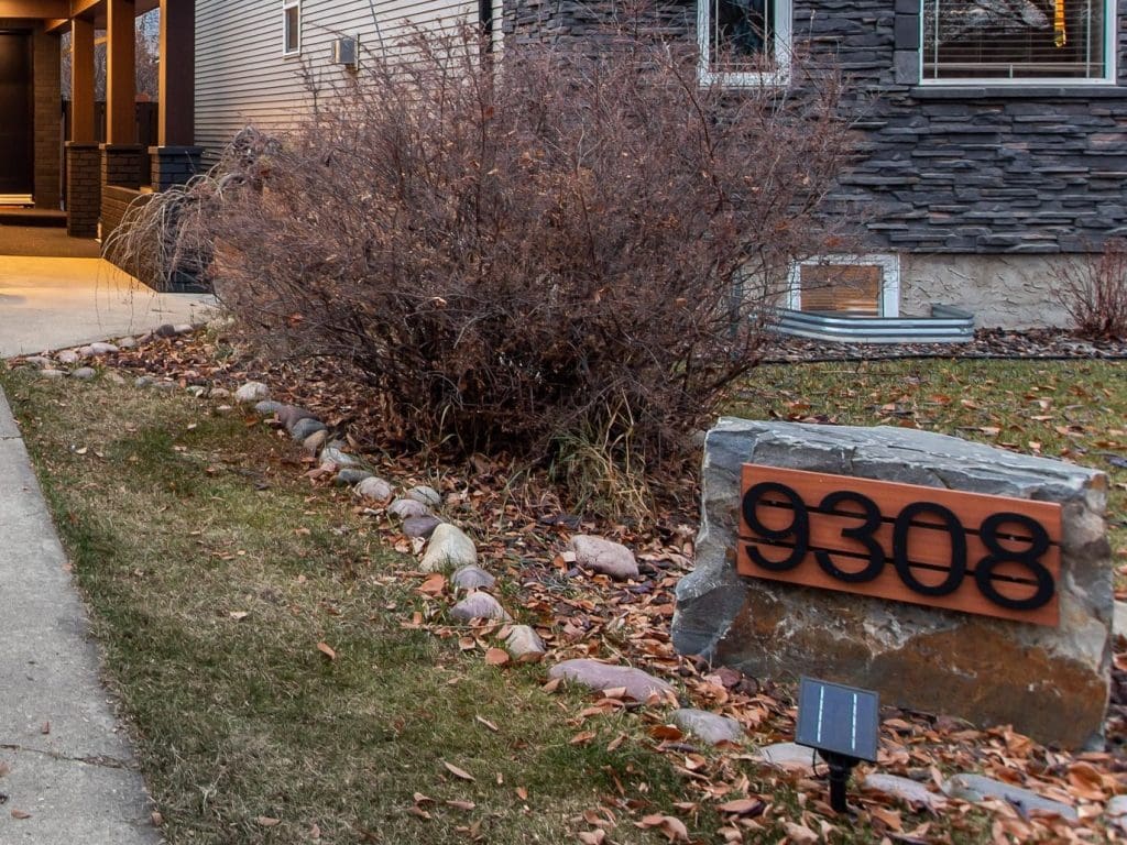 add character to your home exterior with a house number mounted on a boulder