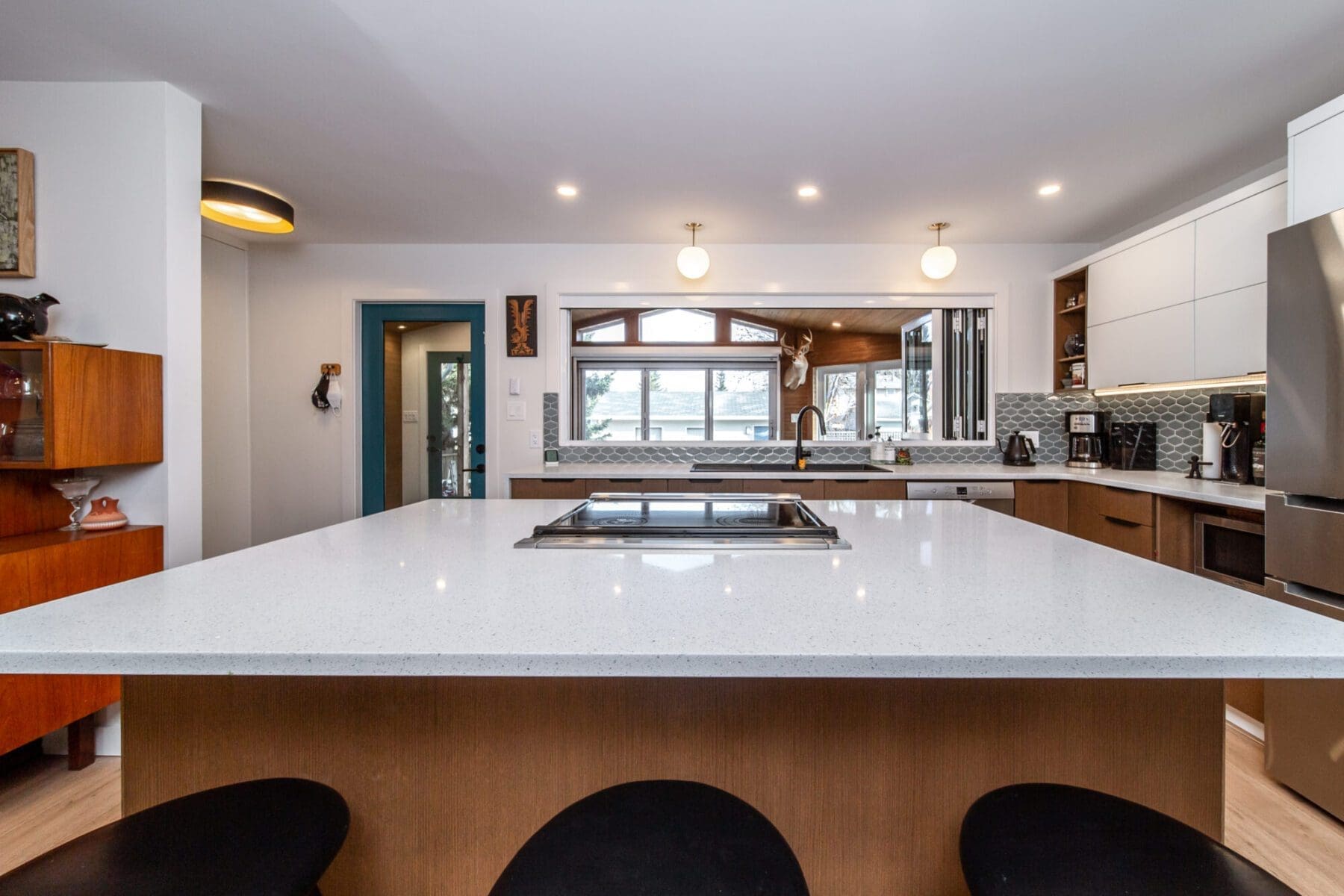 Open concept kitchen with a downdrraft range hood, Contact Renovations blog