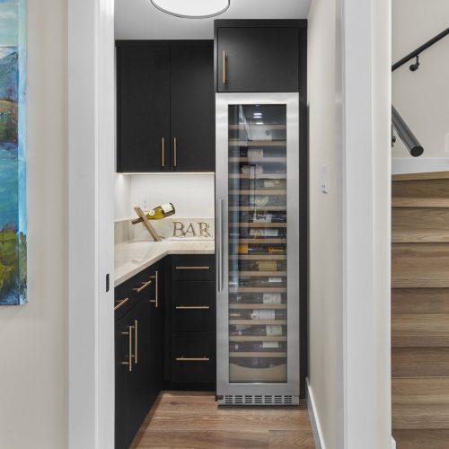 wine room in edmonton with striking black cabinets