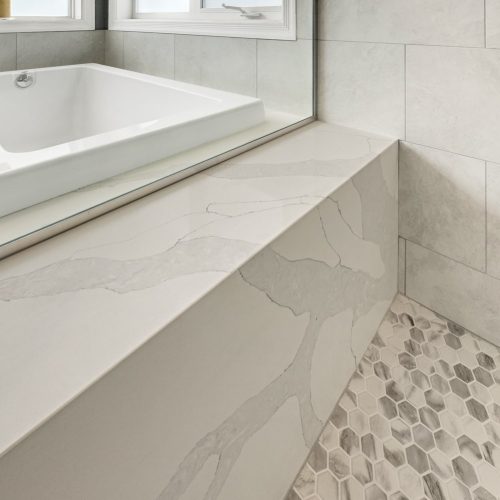 drop-in tub with a quartz deck